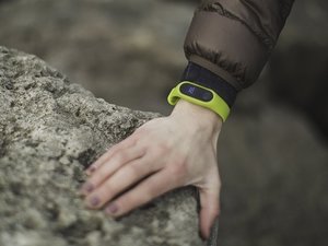 green fitbit on wrist