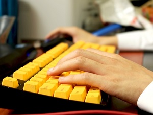 typing on yellow keyboard