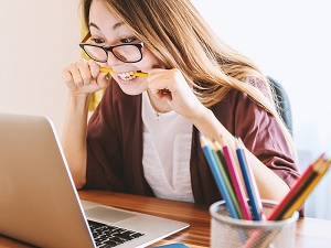 woman chewing pencil