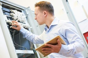 A computer network professional checks a server for issues.