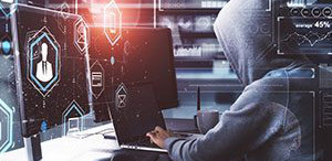A cybercriminal types on a keyboard.