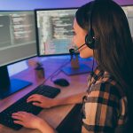 A woman helps a customer over the phone.