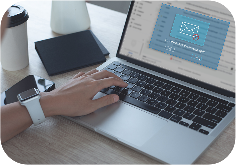 A person is checking email on their laptop with a pop-up box to block messages.