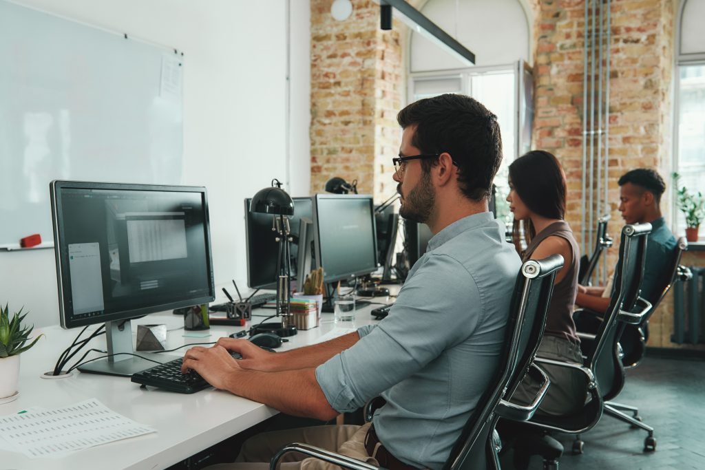 three office workers at their computers