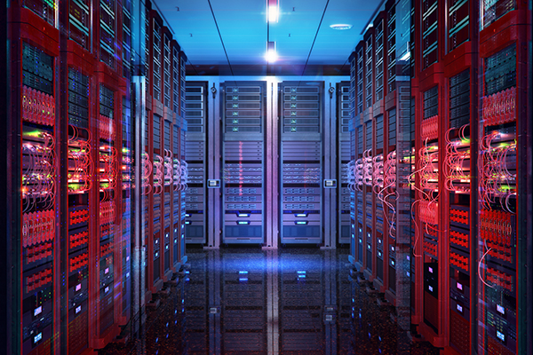 A long hallway of a data center with server racks on either side.